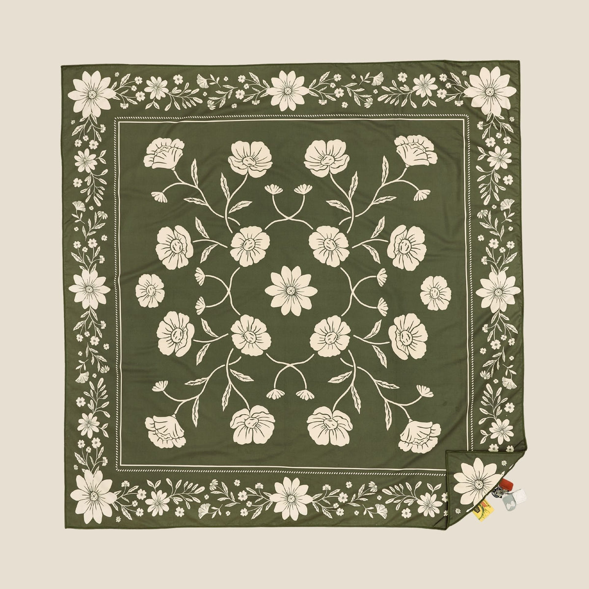 Eden sand free beach towel in XL, olive green floral bandana print, studio flat lay