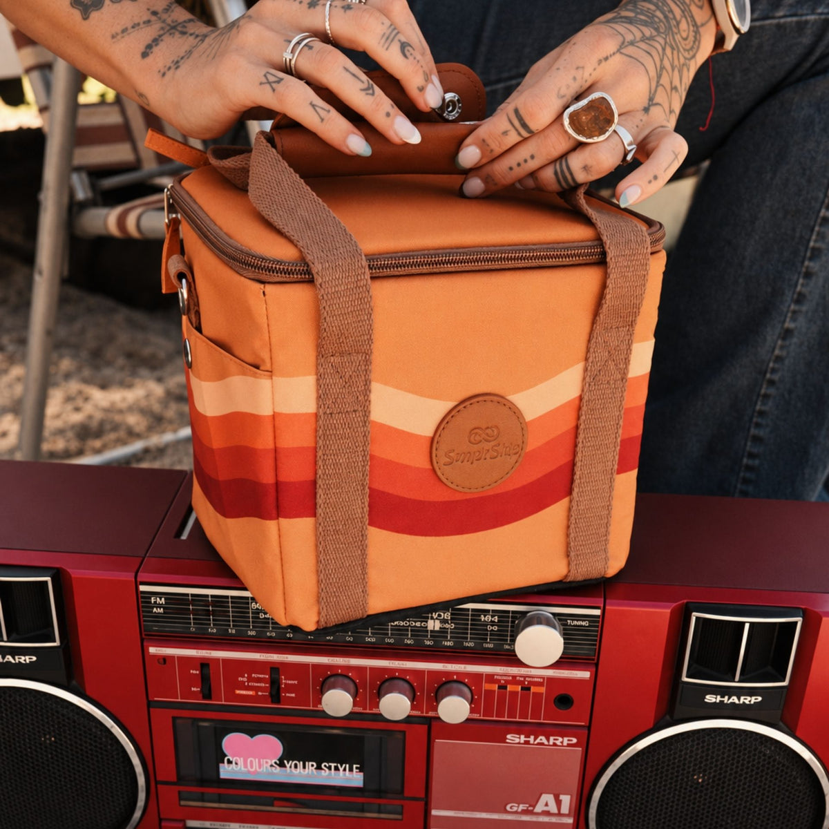 Stevie mini insulated cooler bag, orange retro 70s wave print, on a retro boombox