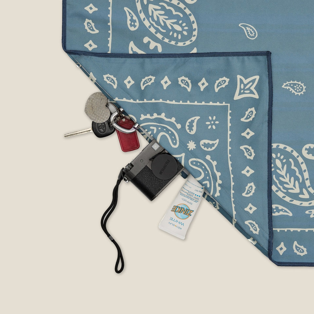 Venice sand free beach towel in Large, dusty blue paisley bandana print, corner detail