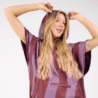 Jagger Shiraz adult hooded towel poncho, burgundy and mauve wavy stripe, on model with hood