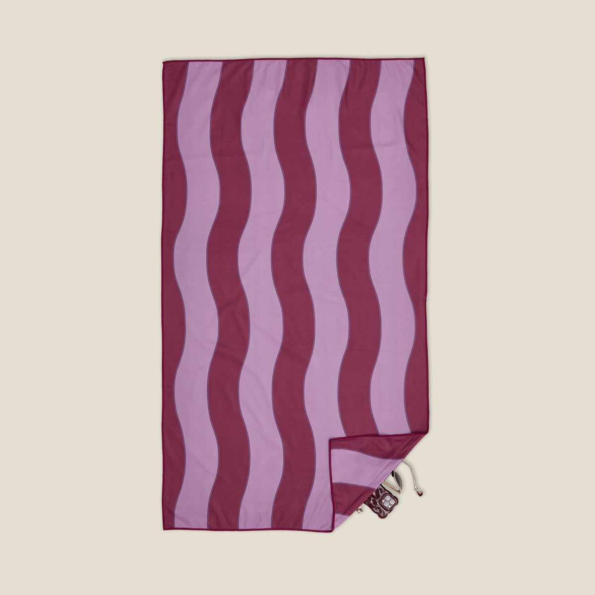 Jagger Shiraz sand free beach towel in Large, burgundy and mauve wavy stripe, studio flat lay