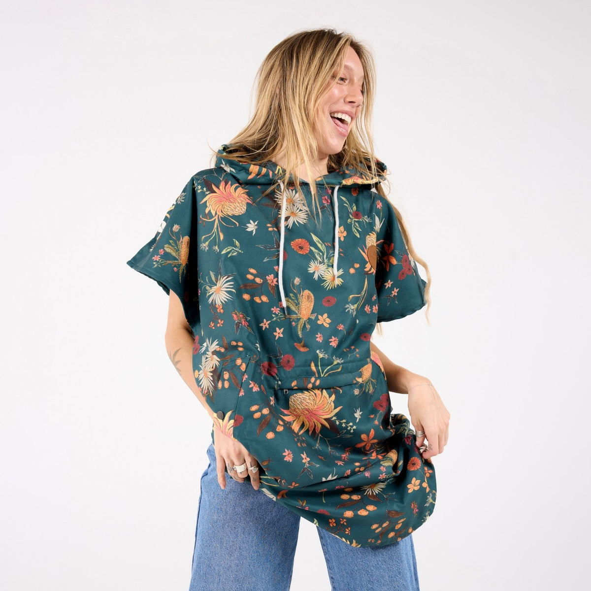 Native Botanical adult hooded towel poncho, dark green Australian wildflower print, front view on model