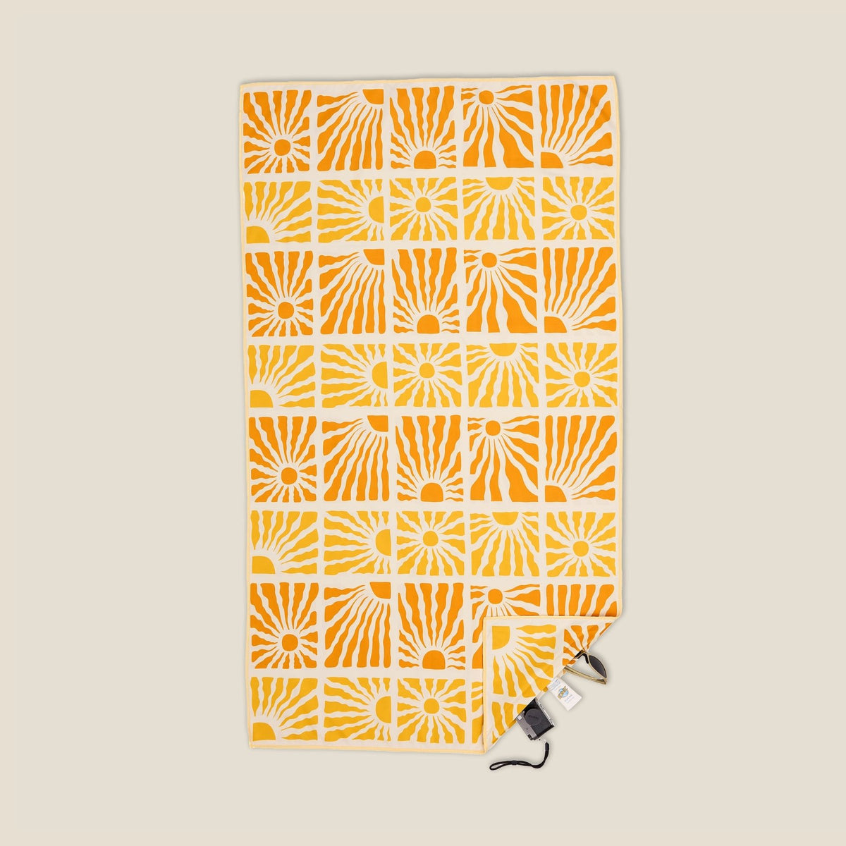 Solstice sand free beach towel in Large, yellow retro sunburst print, studio flat lay