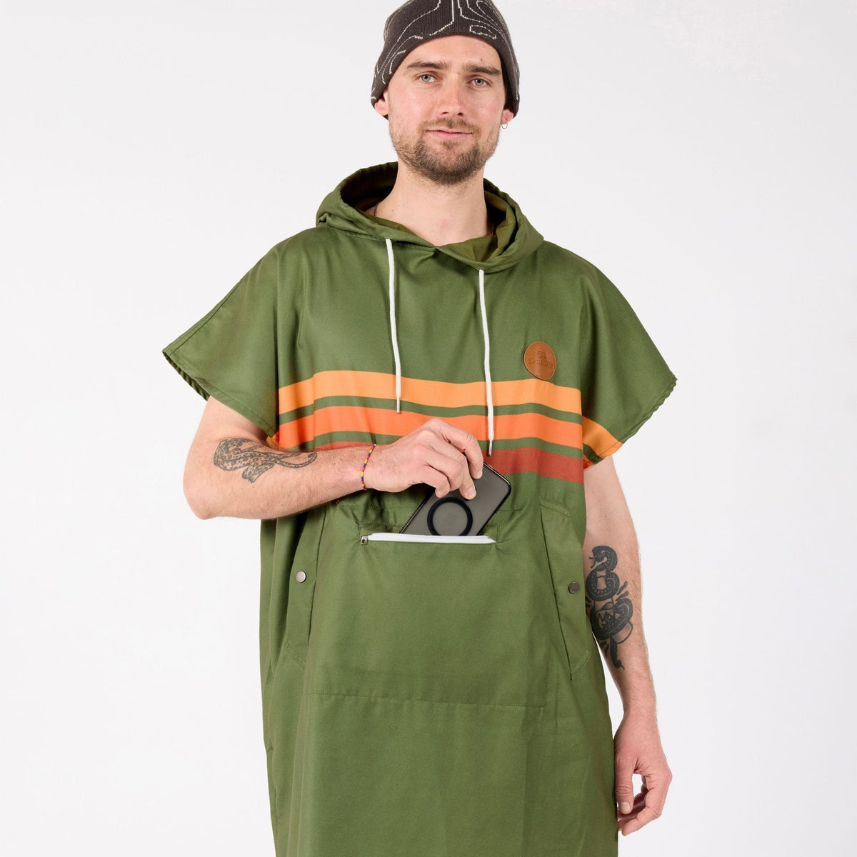 Stevie adult hooded towel poncho, olive green with retro orange stripes, on model using the zip pocket