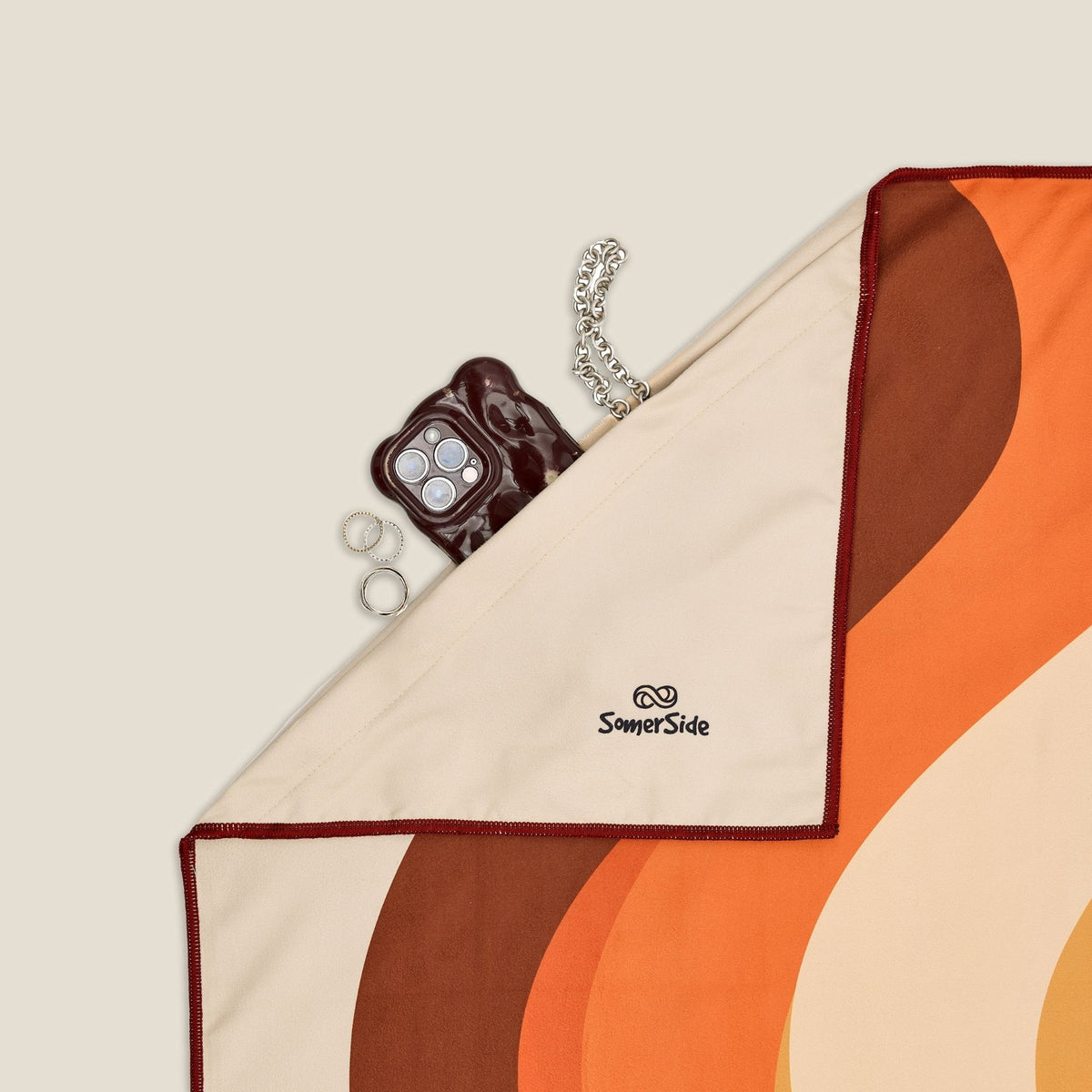 Stevie sand free beach towel in XL, orange retro 70s wave print, corner detail