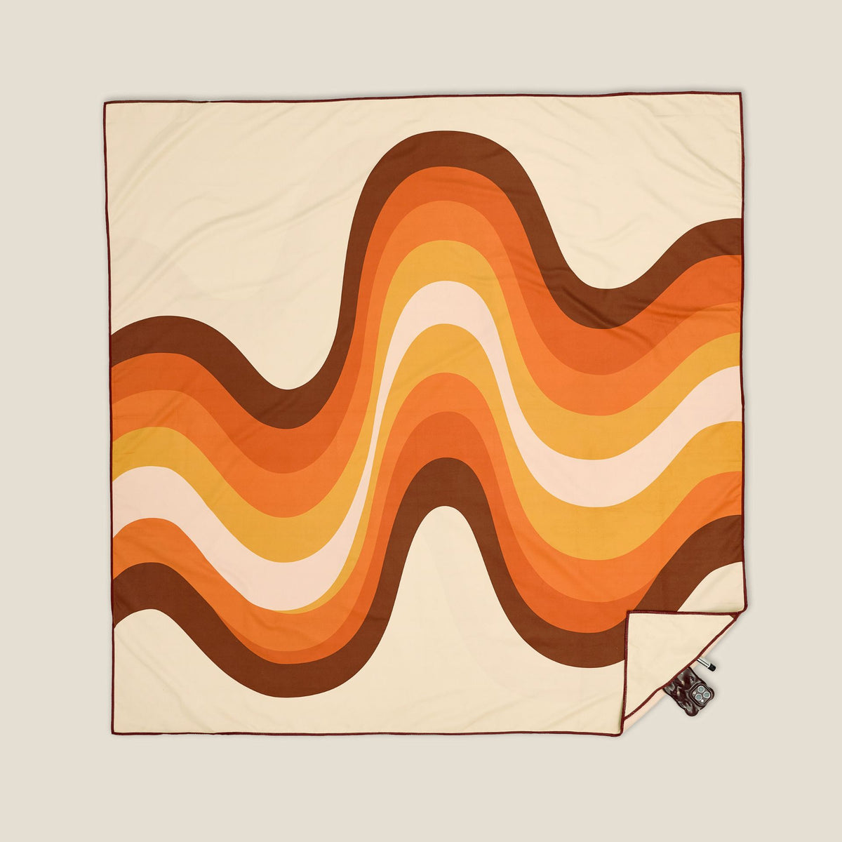 Stevie sand free beach towel in XL, orange retro 70s wave print, studio flat lay
