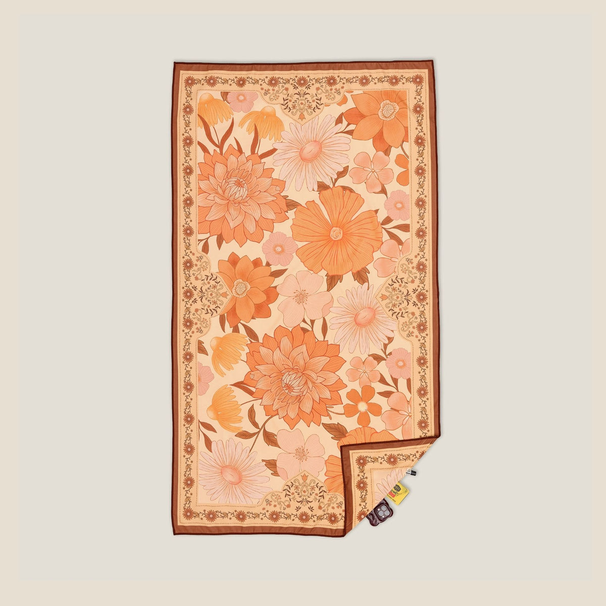 Summer Muse sand free beach towel in Large, peach retro 70s floral print, studio flat lay
