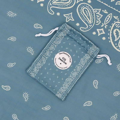 Venice sand free beach towel in Large, dusty blue paisley bandana print, with its carry pouch
