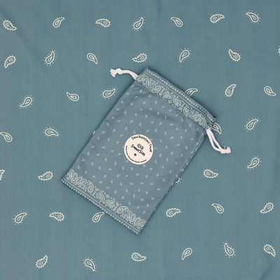 Venice sand free beach towel in XL, dusty blue paisley bandana print, with its carry pouch